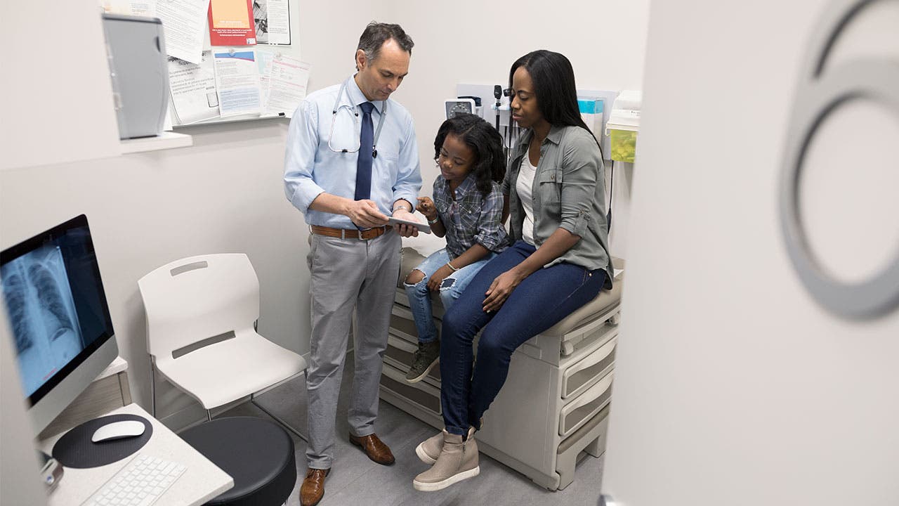 Mother and daughter talking to doctor