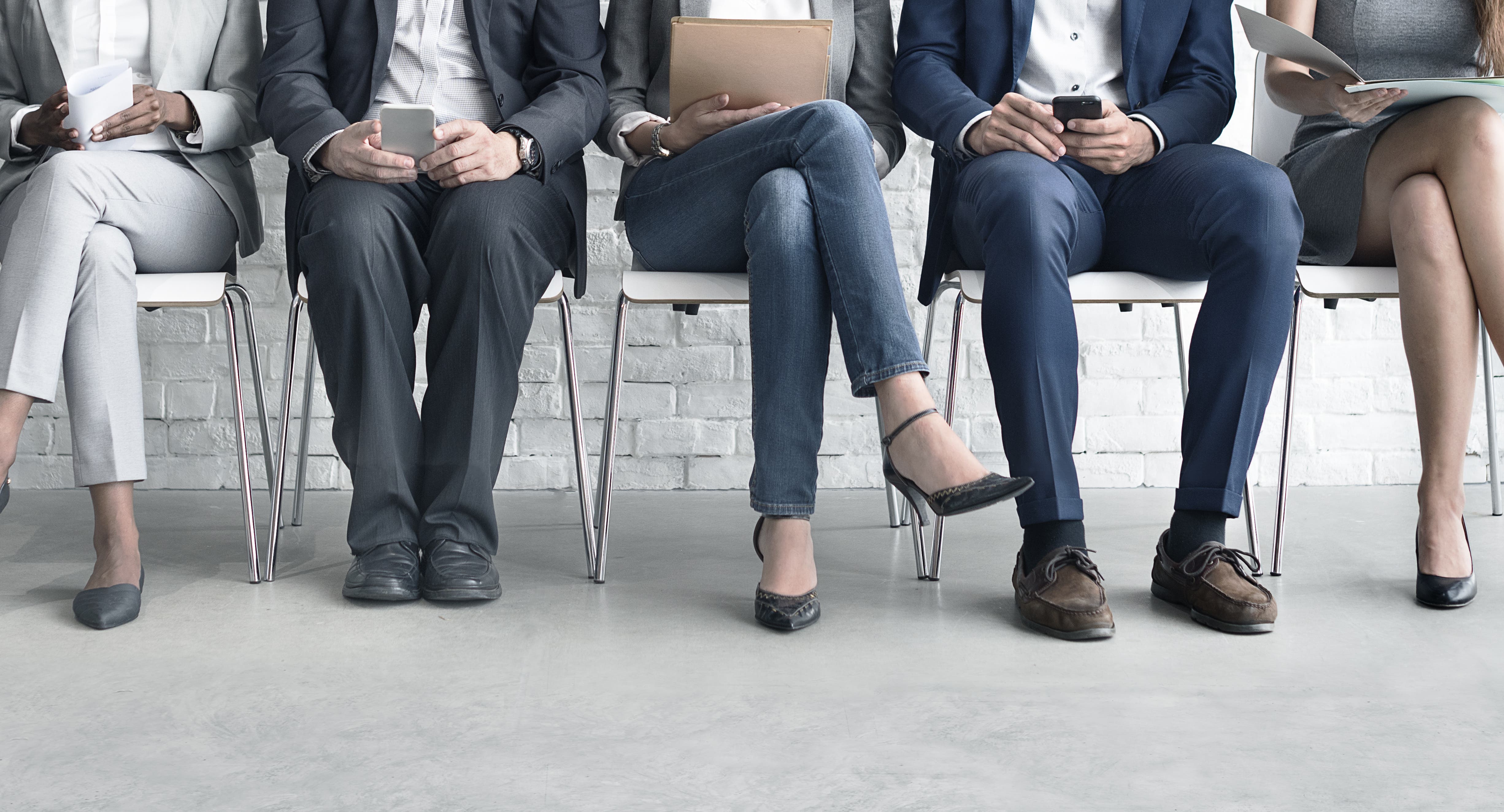 group of people sitting waiting for interview