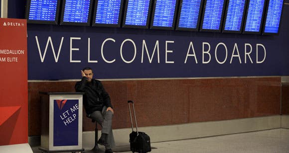 tax-blog-airline-passenger-waiting-underneath-departure-board