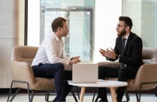 Two men discussing finances.