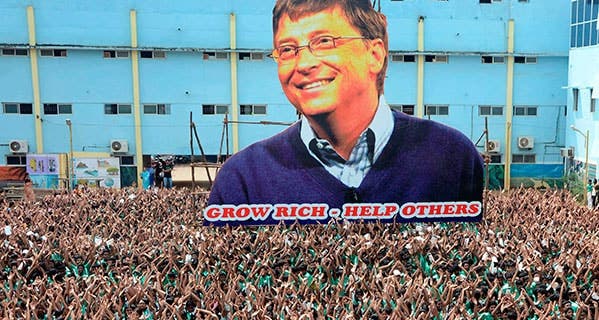Indian schoolchildren gather around a larger-than-life cutout of Microsoft founder and philanthropist Bill Gates, whose foundation focuses on solving health care problems around the world. STR/AFP/Getty Images