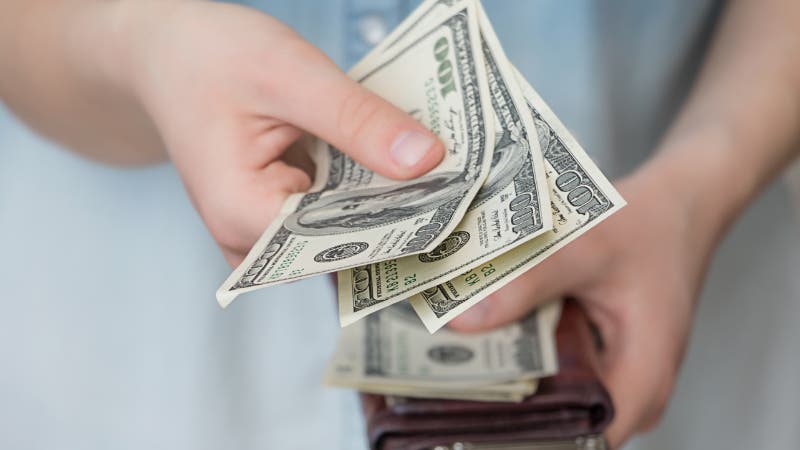 woman getting money from wallet