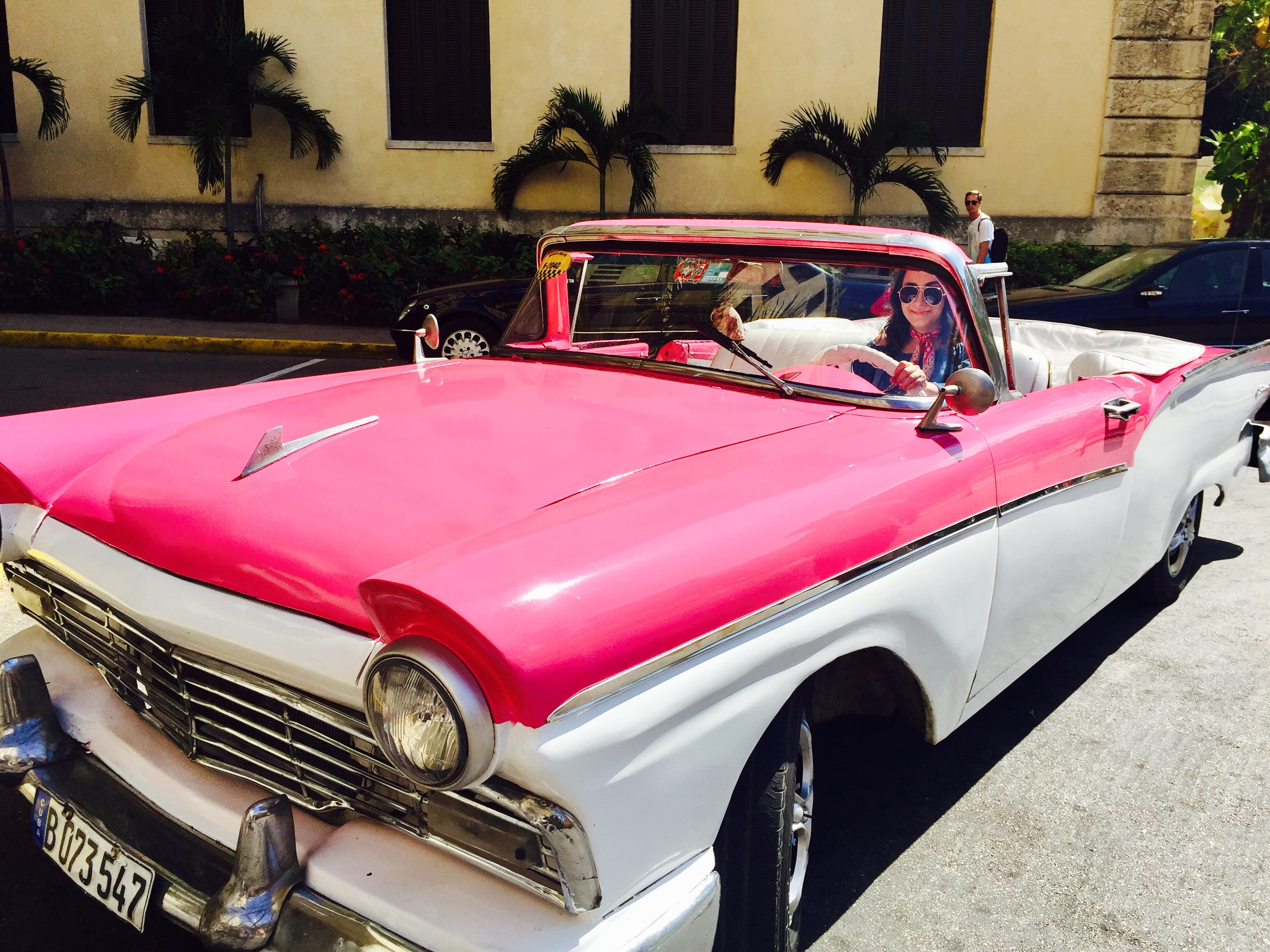 Retro cars zoom down the streets in Havana.