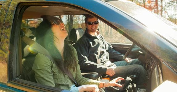 What is summer-blend gasoline and why does it cost more Couple driving in the woods, laughing in their car | Aaron Greene/Blend Images/Getty Images