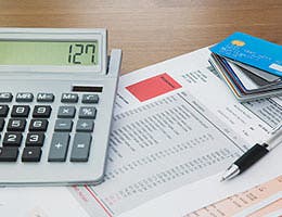 Buried under a pile of debt © jason cox/Shutterstock.com