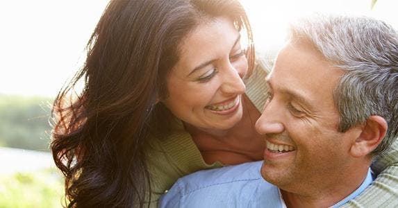 Is it possible to retire young -- in your 30s or 40s? Closeup of smiling couple in their 40s © Monkey Business Images/Shutterstock.com
