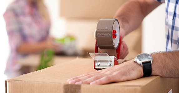Person taping a box