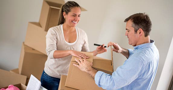 Man and woman packing boxes