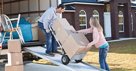Man and woman loading boxes into a truck