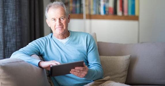 Is there a loophole to avoid capital gains tax? Senior male in light blue sweater browsing tablet | Alistair Berg/DigitalVision/Getty Images