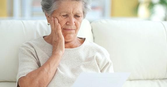 8 costly scams that target senior citizens Upset elderly woman reading a letter | iStock.com
