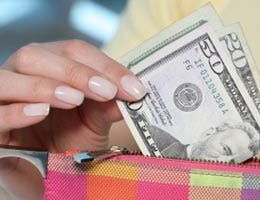 Woman pulling $50 bill from her wallet