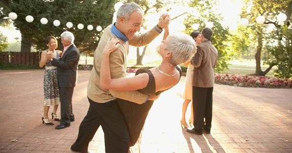 Should you invest in an IRA during retirement? Senior couple dancing in outdoor party | Blend Images/Plush Studios/Bill Reitzel/Getty Images