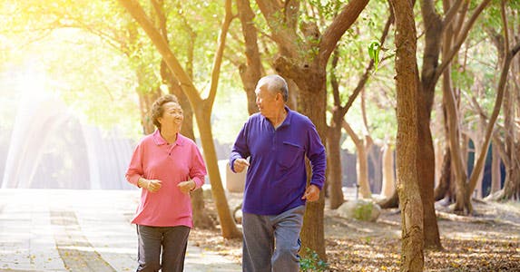 Elder couple walking outdoors © iStock