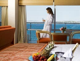 Woman in hotel room with water view
