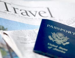 Travel section of newspaper and a passport