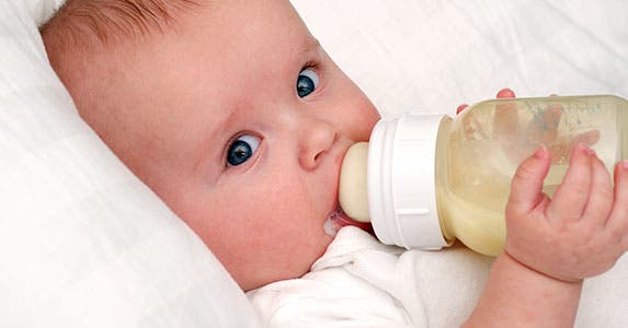 Baby drinking out of milk bottle