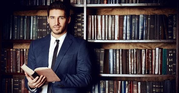 10 must-know IRA terms Businessman holding a book in library © Kiselev Andrey Valerevich/Shutterstock.com
