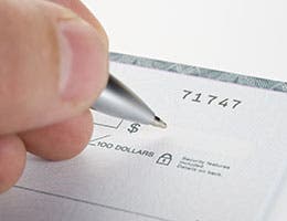 Accepting checks © Nikola Bilic/Shutterstock.com