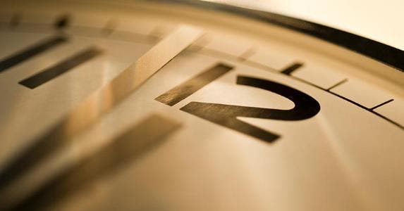 Should you invest in an IRA during retirement? Close up of analog clock on 12 o'clock | Tetra Images/Getty Images
