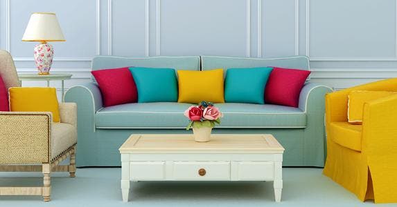 Blue living room with blue sofa and colorful pillows © JZhuk/Shutterstock.com