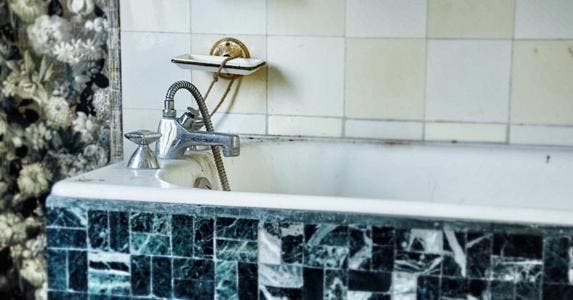 How to get the most from selling a home 'as-is' Outdated bathtub | David Bise / EyeEm/Getty Images