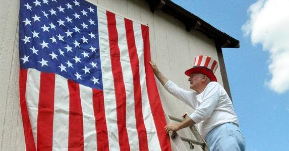 Flapping, snapping flag drives nappers mad Senior man fixing U.S. flag hanging on wall | Dorann Weber/Getty Images