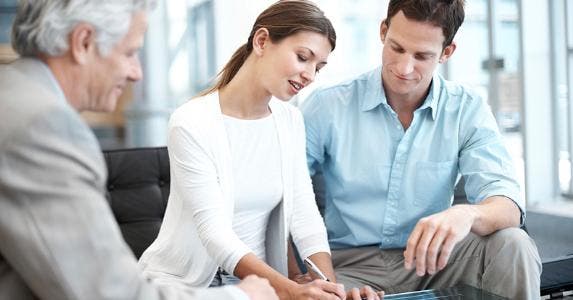 Young couple signing forms © iStock