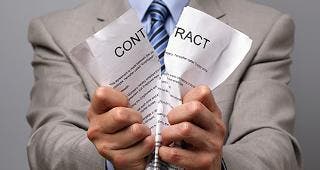 Man in suit ripping contract in half © Brian A Jackson/Shutterstock.com
