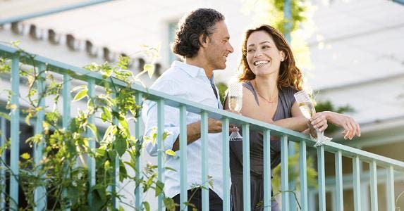 Couple standing on terrace © MJTH/Shutterstock.com