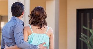 Couple looking at house © AntonioDiaz/Shutterstock.com