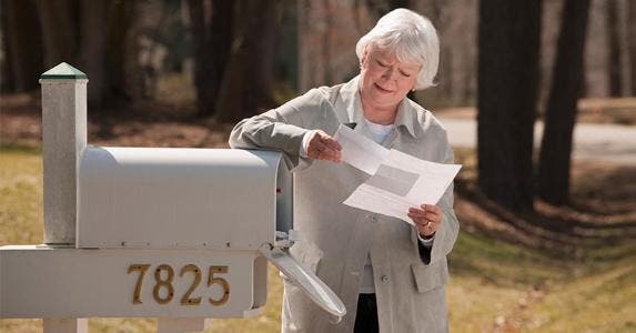Should I refuse to grant a contract extension? Woman leaning on mailbox, reading mail | Mark Edward Atkinson/Getty Images
