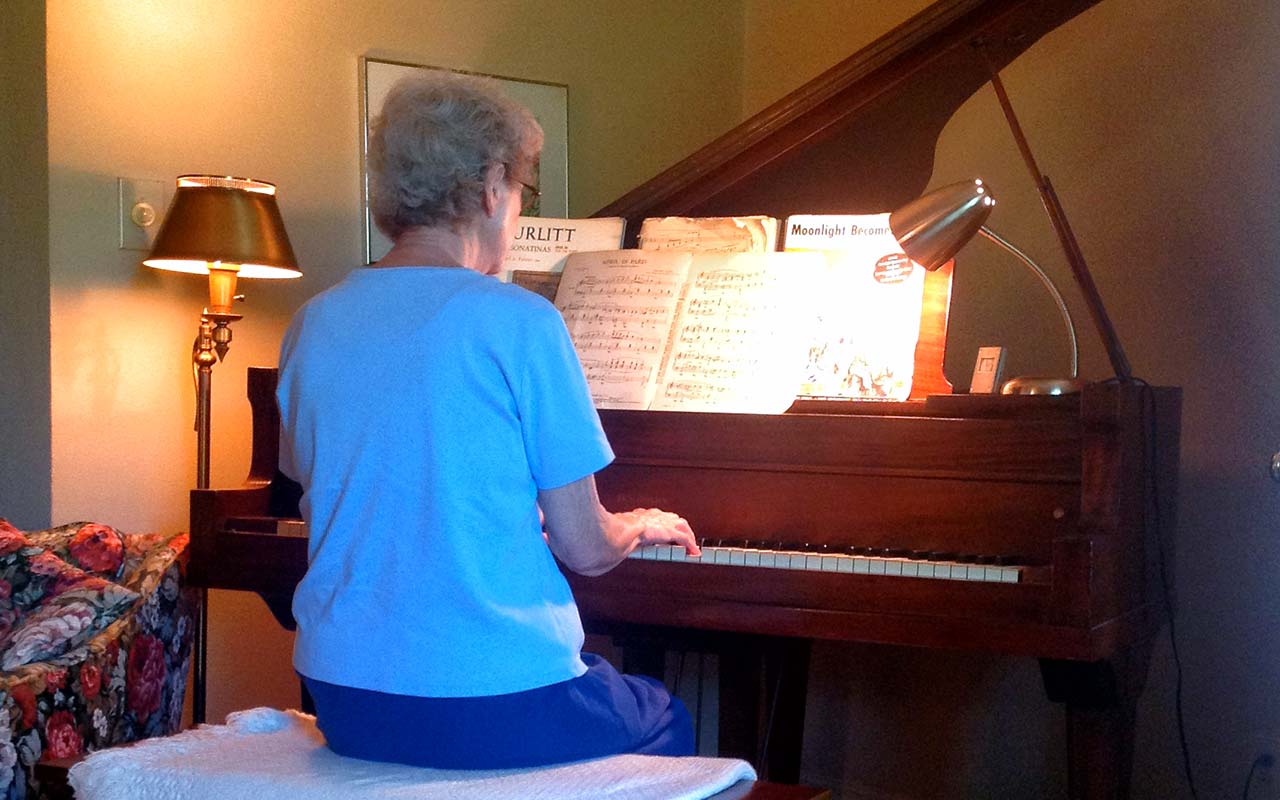 Holden's mother playing the piano