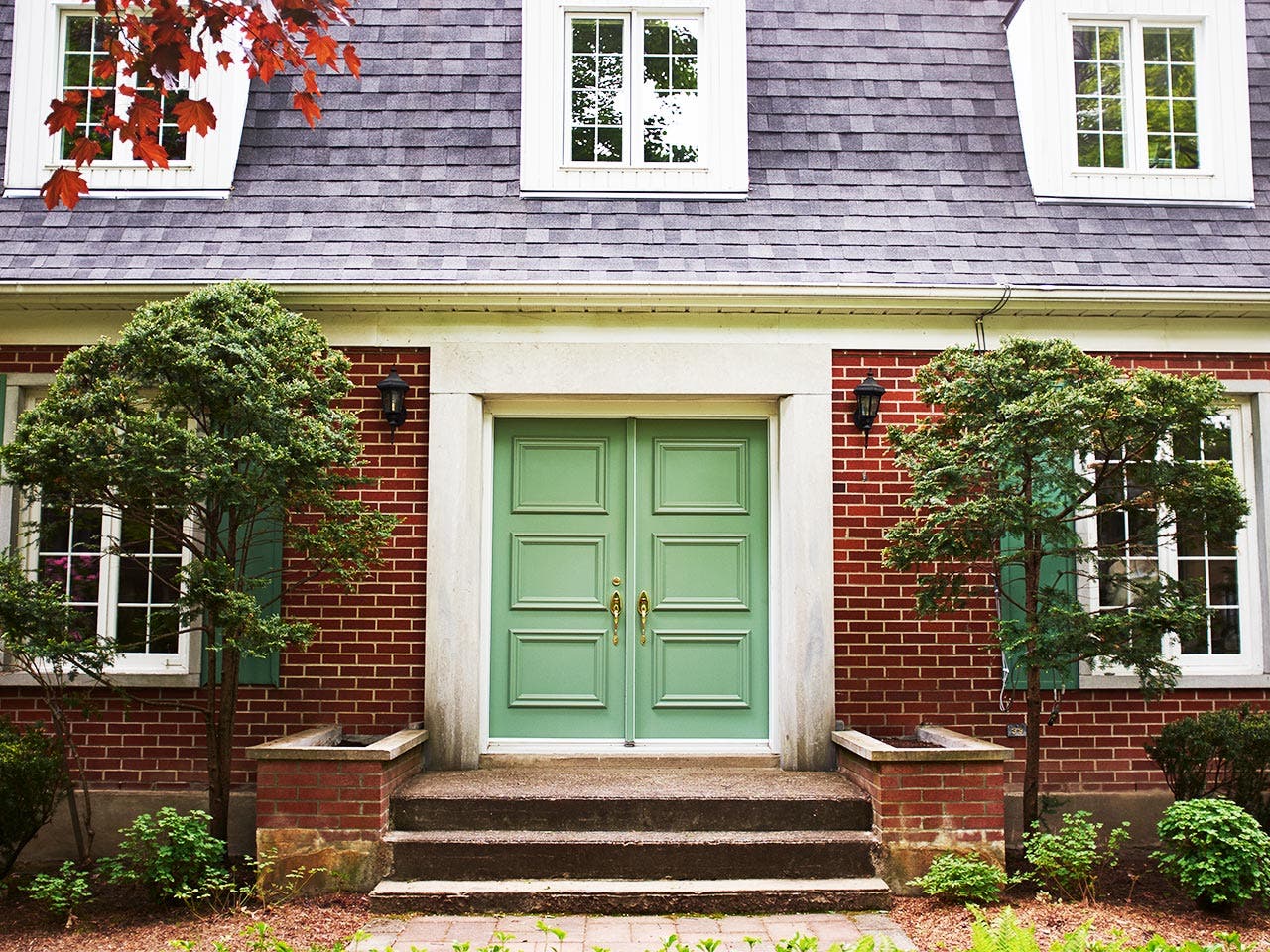 Front of house showing green double doors