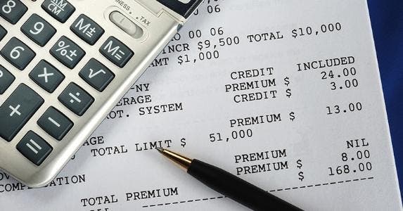 Calculator on insurance bill © JohnKwan/Shutterstock.com