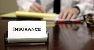 Agent with insurance card on desk © Lane V. Erickson/Shutterstock.com
