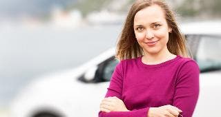 Woman standing outside car © magicinfoto/Shutterstock.com