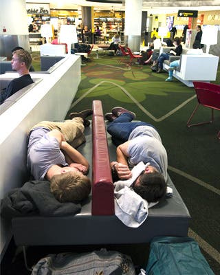 Sleeping in airport: © ChameleonsEye/Shutterstock.com