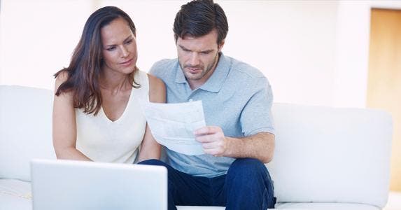 Couple reviewing paper together