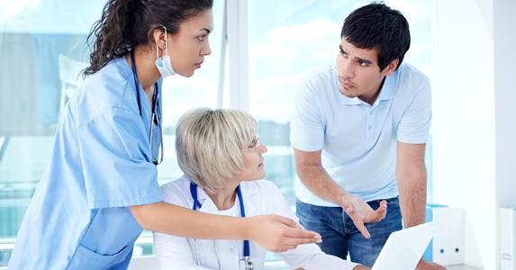 Annoyed patient discussing with medical office staff © iStock