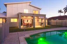 Large pool in backyard of modern home © iStock