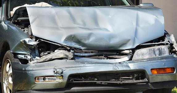 Crushed front hood of car © iStock