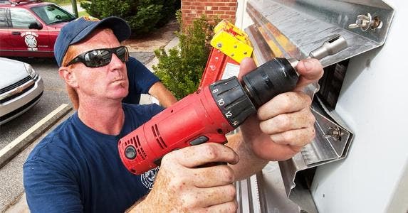 Disaster planning: Are you ready for the worst? Installing hurricane shutters | PAUL J. RICHARDS/Getty Images