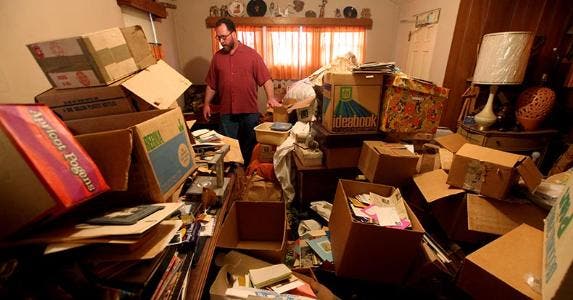 Is it tough for hoarders to get home insurance? Male hoarder at home © Sandy Huffaker/Corbis