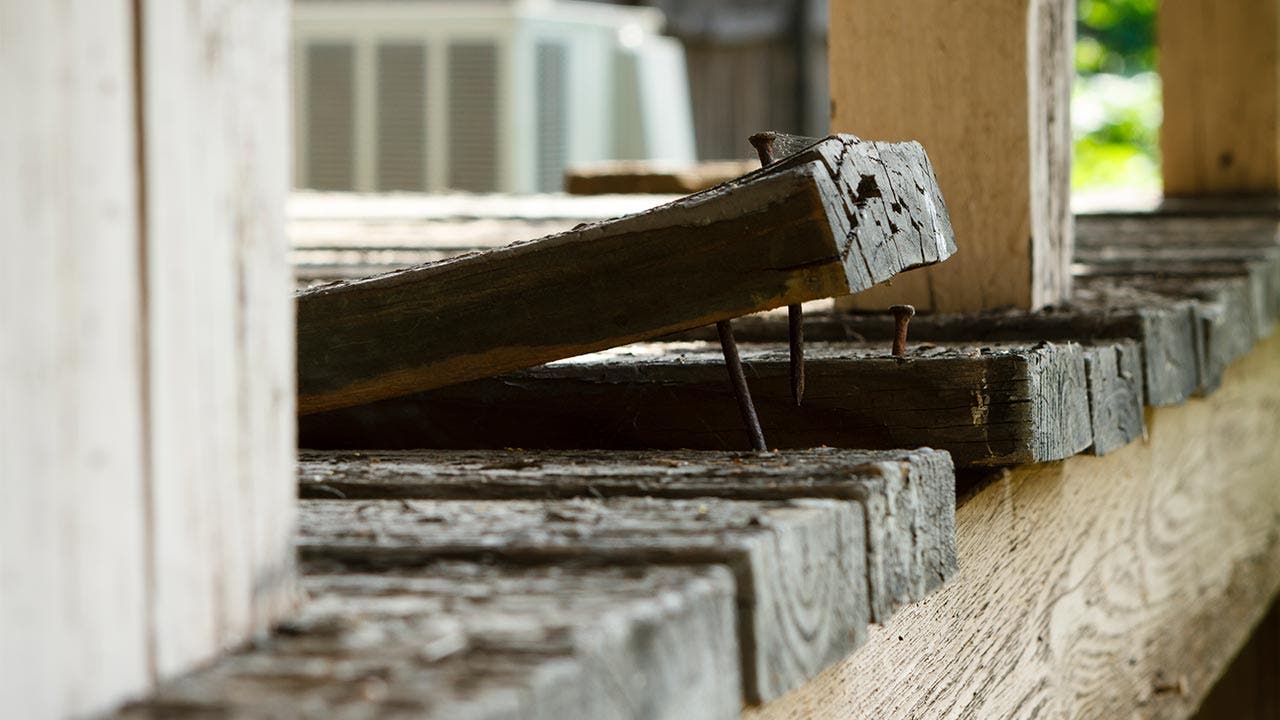 Wooden plank angled up and away from floor