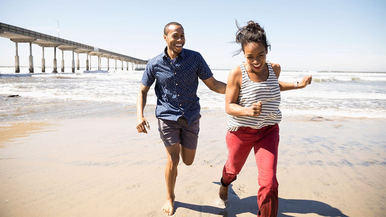 Young couple running on the beach