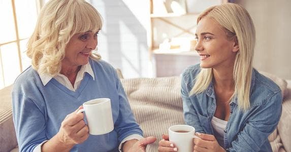 Who has to file taxes? Mother and daughter chatting over coffee | VGstockstudio/Getty Images