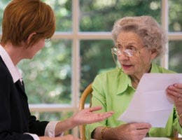 A senior and younger woman talking