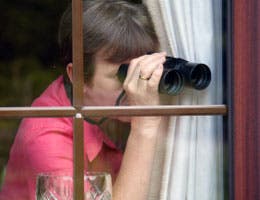 Nosy woman spying on neighbors