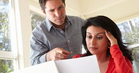 Husband and wife looking over documents © iStock